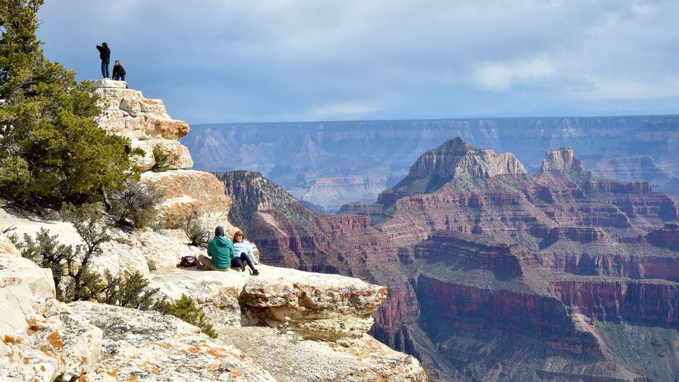 Tourists take photos from the North Rim of the Grand Canyon on May 18, 2015.