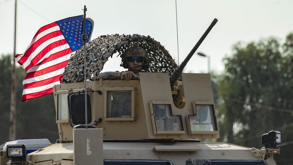 A US soldier in an armoured vehicle in northern Syria