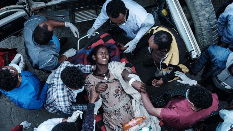 A woman lies on a stretcher after being injured by the bomb blast in Togoga