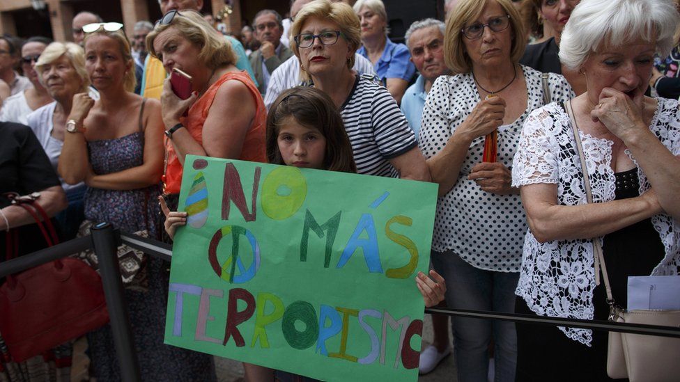 "No more terrorism" sign held by a young girl