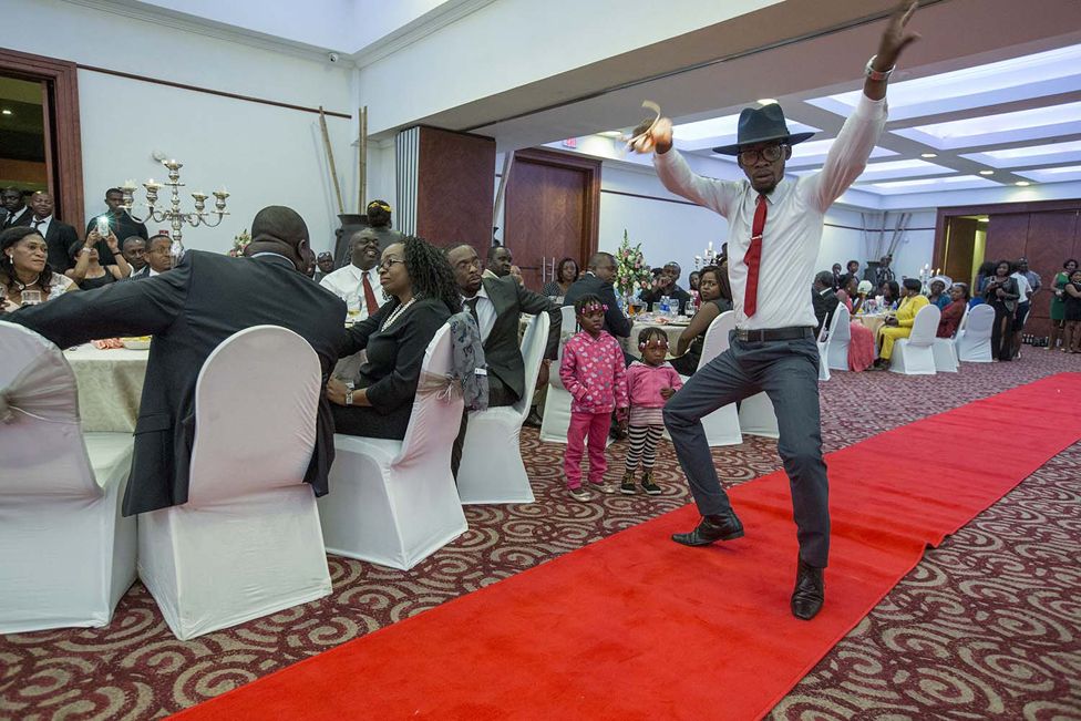 A groom dances at a wedding