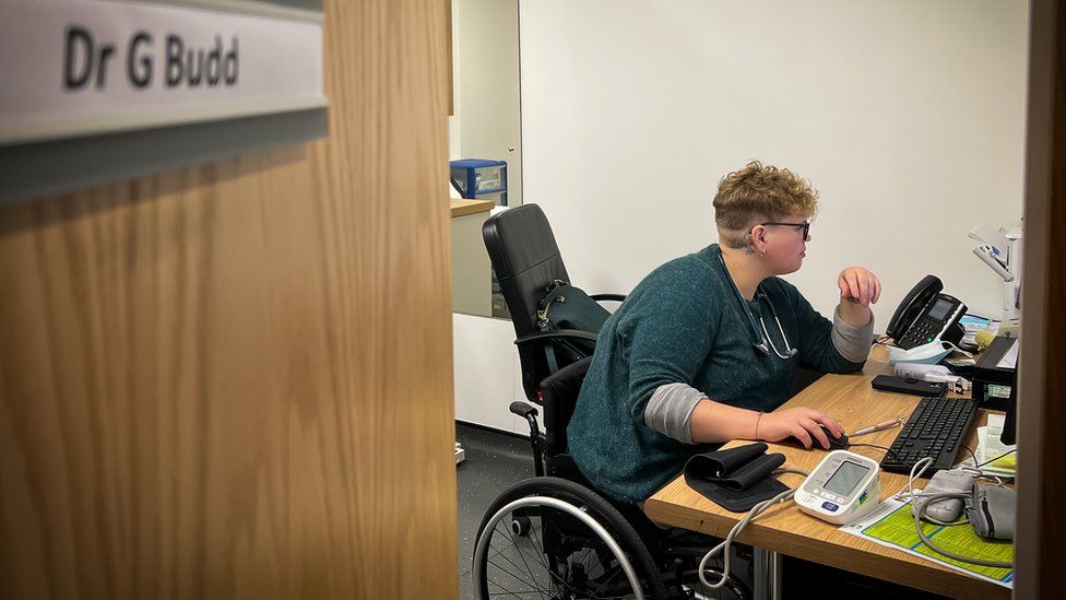 Georgie in her wheel chair in GP treatment room