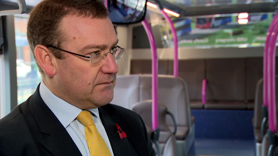Andrew Jarvis, managing director of First Bus, being interviewed on a bus