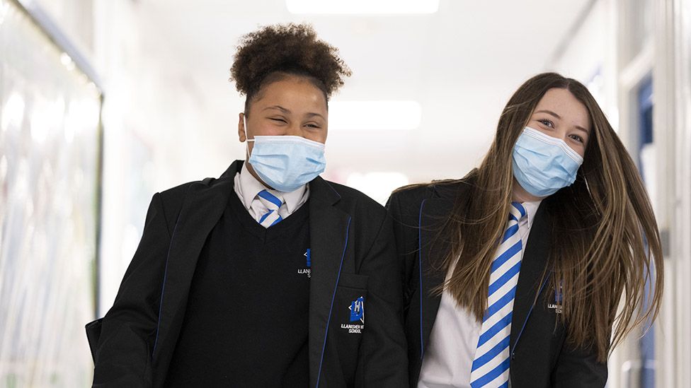 Children wearing face masks walk down a corridor at Llanishen High School, Cardiff, on September 20, 2021