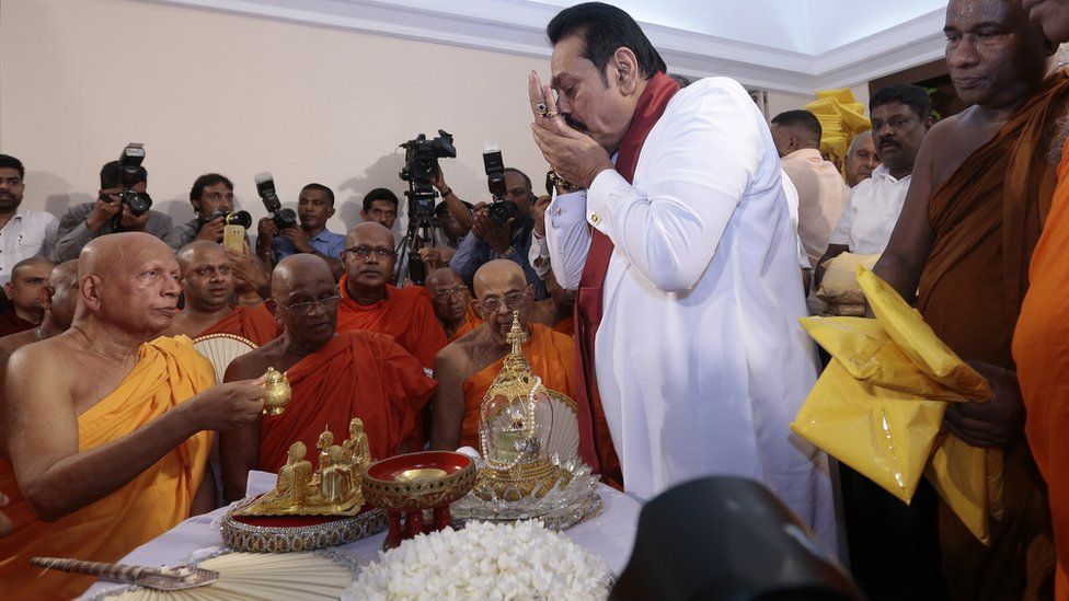 Sri Lanka's former president Mahinda Rajapaksa receives blessings from Buddhist monks before assuming duties as the new Prime Minister at the Prime Ministers office in Colombo, Sri Lanka 10-29-2018.