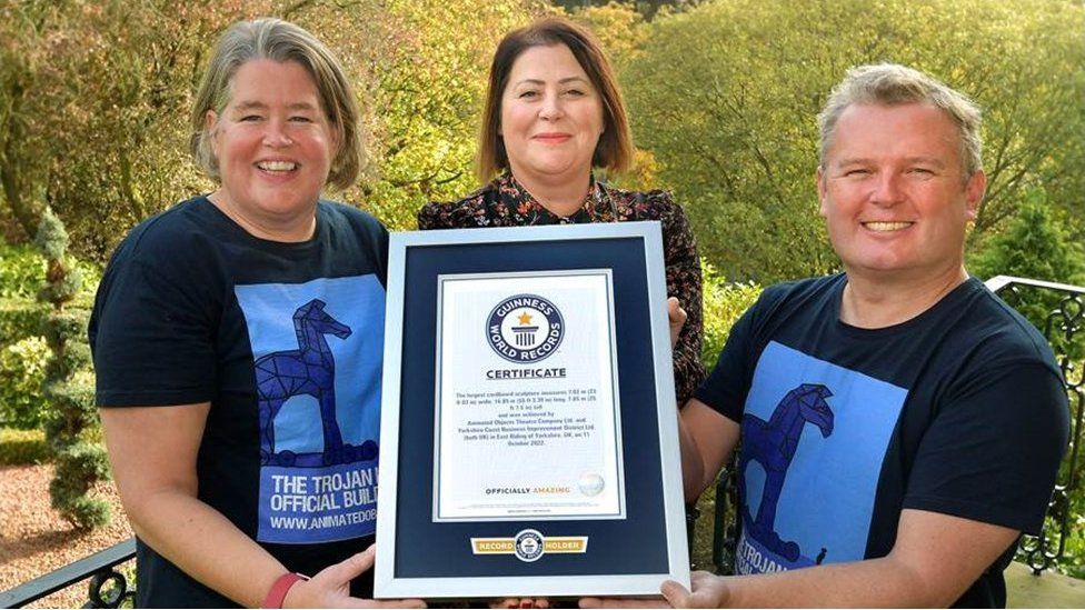 People holding world record certificate