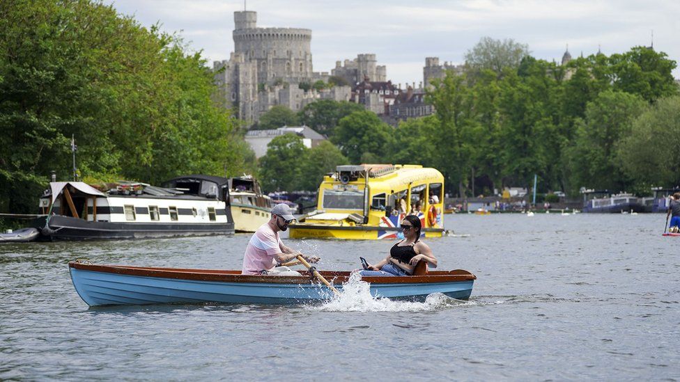 People enjoy boats on the River Thames in Windsor, Berkshire