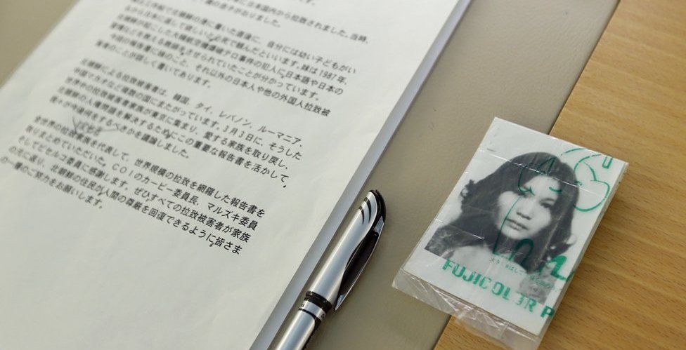 A picture of abduction victim Yaeko Taguchi lies next to a text prepared by her brother Shigeo, for the UN Human Rights Council in 2014