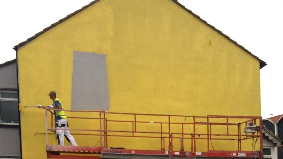Wall being painted yellow