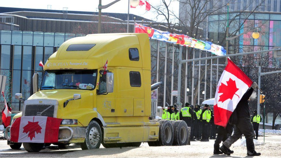 A truck carrying a Canadian flag participates in the protest in downtown Ottawa