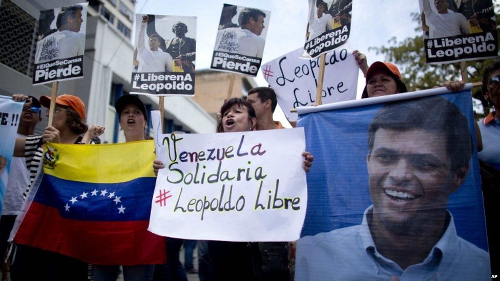 People chant slogans in support of jailed opposition leader Leopoldo Lopez, outside the courthouse in Caracas, Venezuela, Thursday, Sept. 10, 2015.
