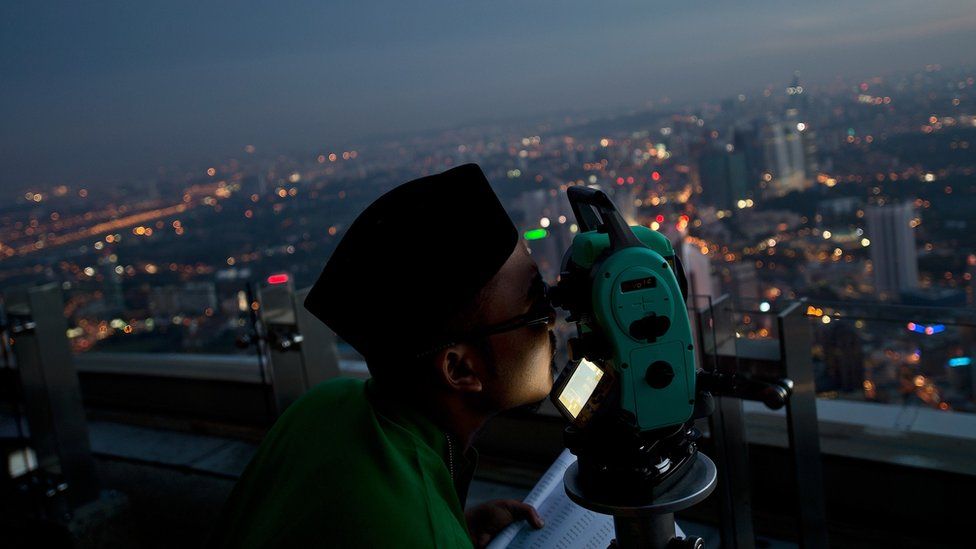 A Malaysian Islamic authority official performs the sighting of the new Moon to determine Eid al-Fitr in Kuala Lumpur, Malaysia. 16 July, 2015