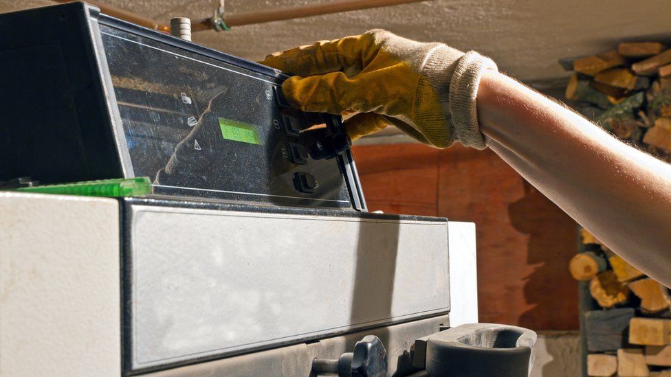 A man operating a biomass boiler