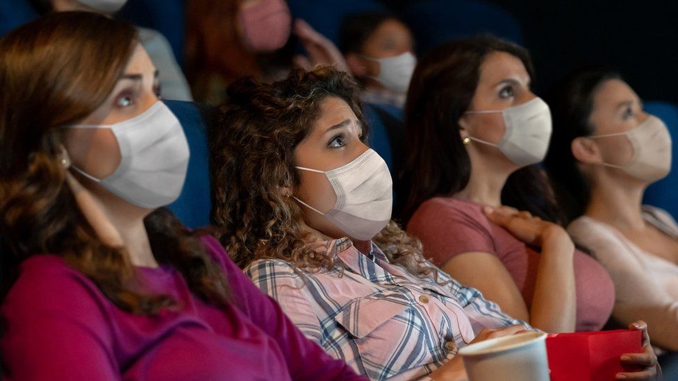 Audience members wearing facemasks
