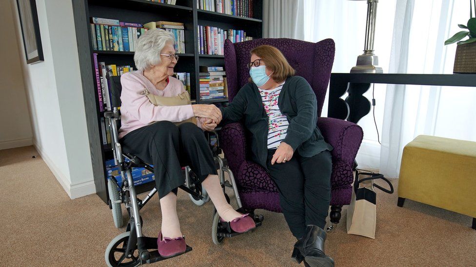 Sylvia Newsom and her daughter Kay Fossett, who haven"t seen each other since December, enjoy their first visit following the easing of rules at Gracewell of Sutton care home in South London.
