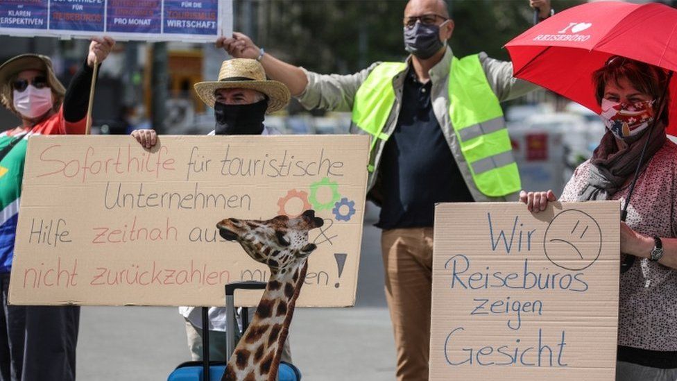 Employees of travel agencies, tour operators and bus companies, wearing face masks and keeping social distancing, demonstrate to demand support and rescue funding in Frankfurt am Main, Germany, 29 April 2020