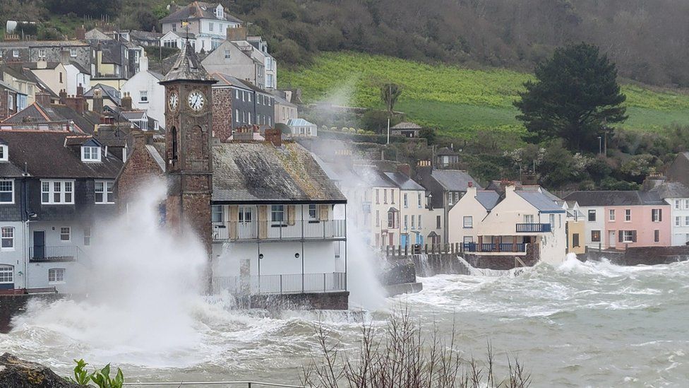 Waves crashing into buildings in Cawsand, Cornwall