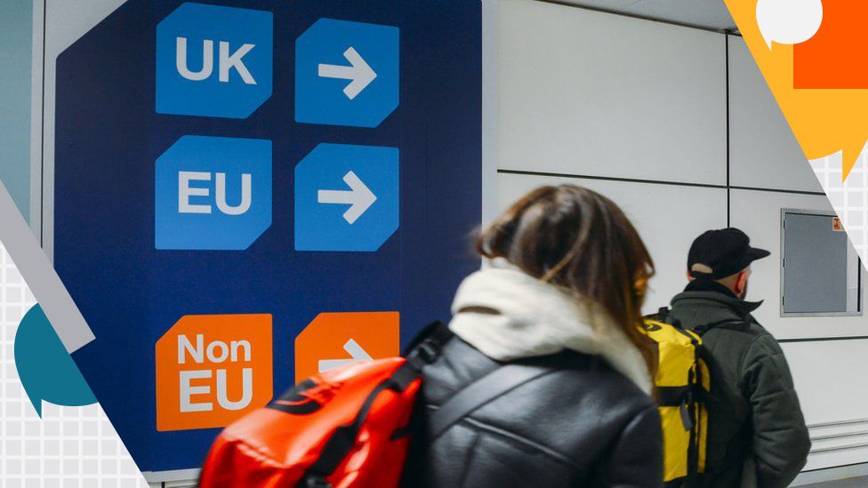 Woman carrying rucksack by UK/EU signs