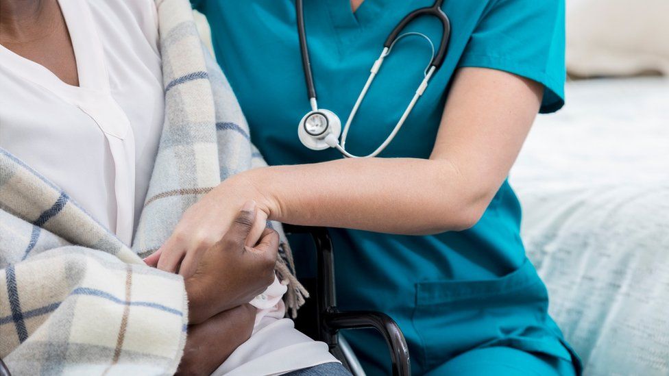 Stock image of a nurse caring for a patient