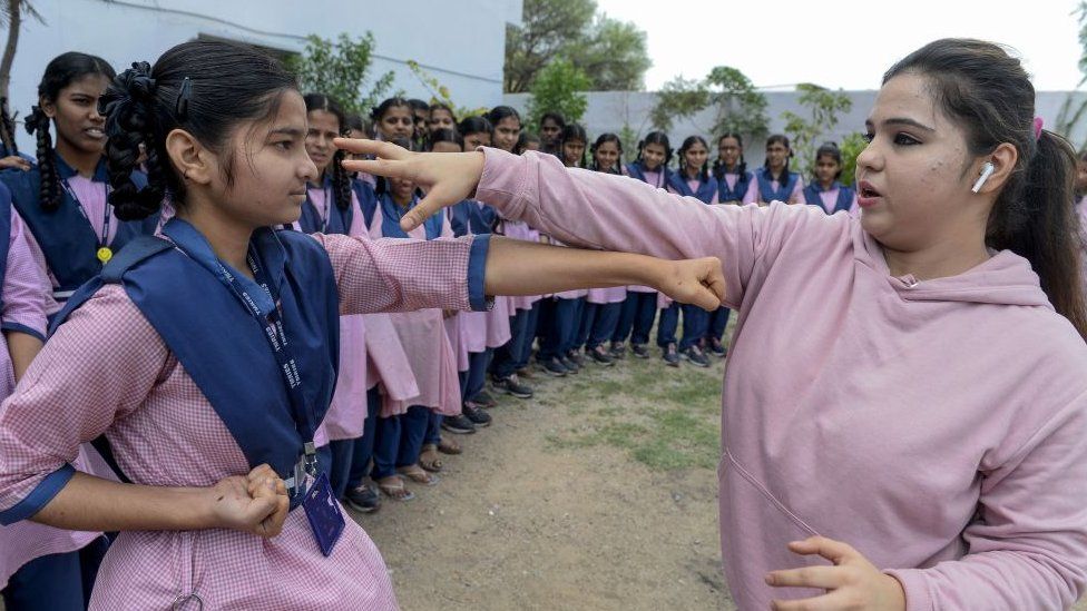 Indian Muslim international karate champion, Syeda Falak (R), shows self-defence techniques to a student at the Telangana Minorities Residential Girls School in Hyderabad on June 17, 2019.