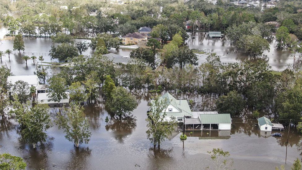 Aerial images show whole neighborhoods submerged.