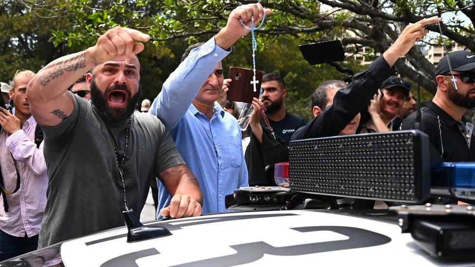 Pro Catholic supporters yell during a protest by an LGBTI group outside the pontifical requiem Mass for Cardinal George Pell.