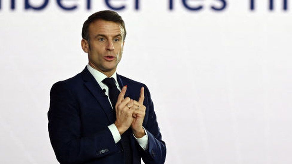 French President Emmanuel Macron addresses a speech during a visit to mark the two years of the France 2030 investment plan at the Airbus site in Toulouse, south-western France, on December 11, 2023