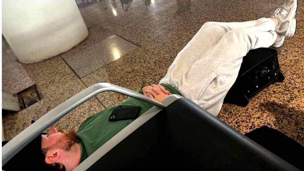 Scott Coyle sleeping on the airport floor