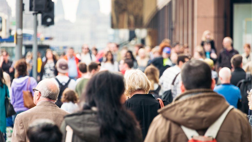 People walking down a street in Edinburgh