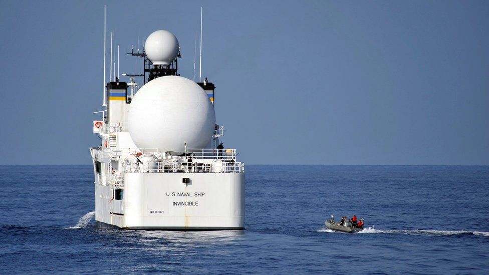 U.S. sailors in a rigid-hull inflatable boat approach the Military Sealift Command missile range instrumentation ship USNS Invincible (L) to conduct a personnel transfer in Arabian Sea on November 21, 2012.