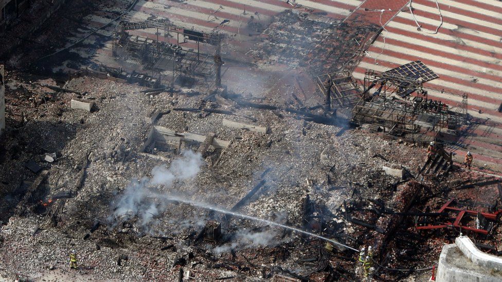 An aerial photograph shows the destroyed Shuri Castle in Naha