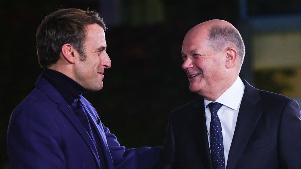 French President Emmanuel Macron greeting German Chancellor Olaf Scholz.