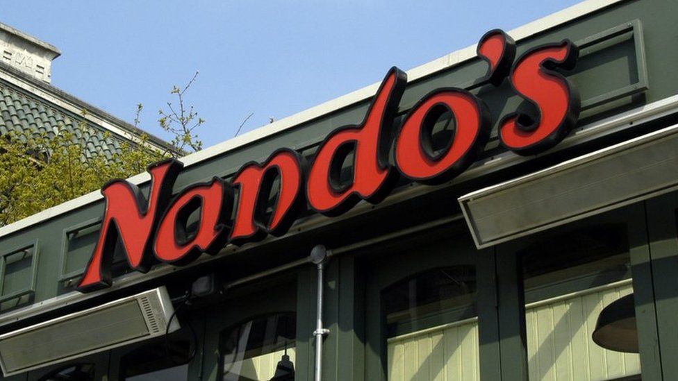 The Nando's logo above a restaurant