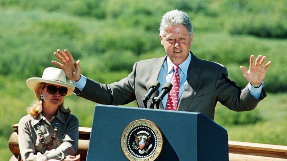 US President Bill Clinton (R), accompanied by First Lady Hillary Clinton, gives a speech on August 26, 1995 for the 75th anniversary of the Voting rights for Women in the United States in Jackson Hole.