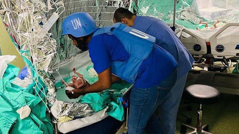 UN personnel looking after one of the babies