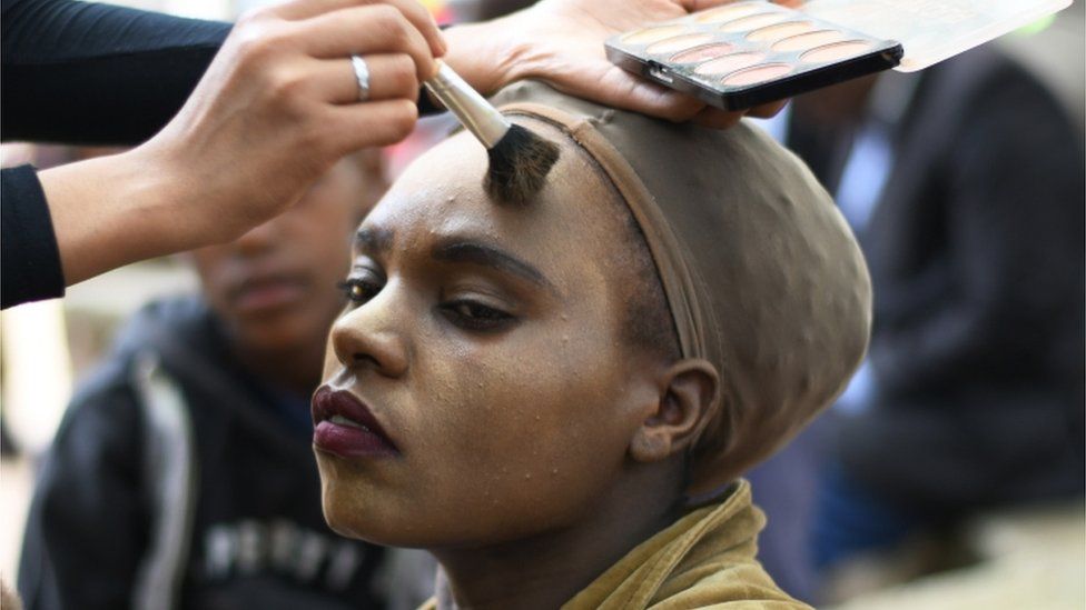 A woman gets her make-up done during the Valentine Street Family Bash in Nairobi on 14 February 2020.