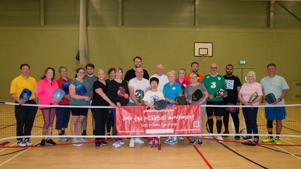 Pickleball players on the Isle of Man posing for a photo