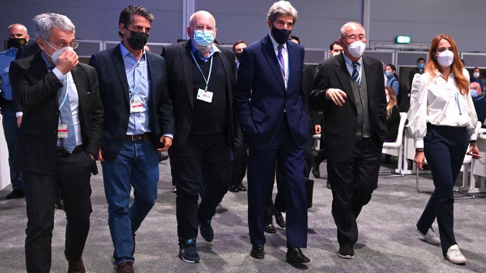 US Special Presidential Envoy for Climate John Kerry (4th L) and Chief Negotiator of China, Xie Zhenhua (5th L) leave the room at the UN Climate Change Conference COP26 on November 13, 2021 in Glasgow, Scotland.