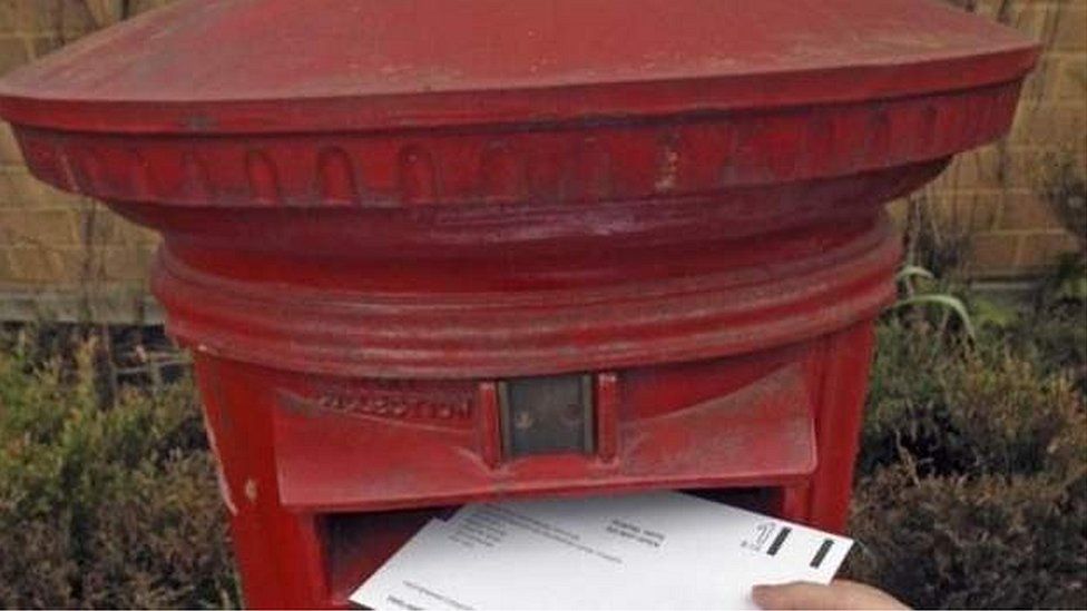 Postal ballot being put in letter box