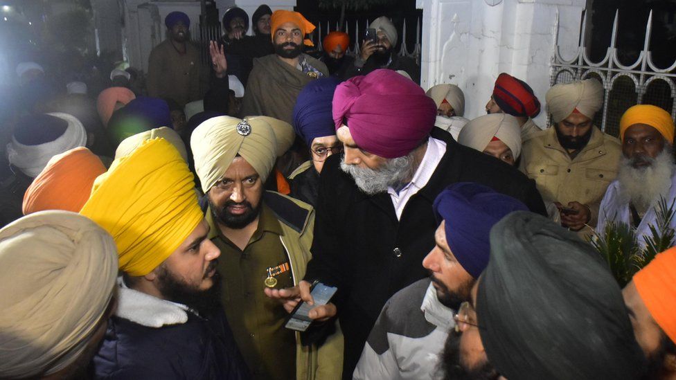 Police officials trying to pacify the Sikh activists gathered outside Teja Singh Samundri Hall Shiromani Gurdwara Parbandhak Committee (SGPC) head office after sacrilege attempt at Golden Temple, on December 18, 2021 in Amritsar, India