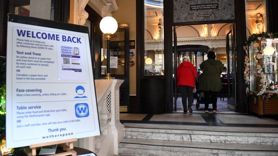 Customers arrive at a re-opened Wetherspoons pub in Glasgow on April 26,