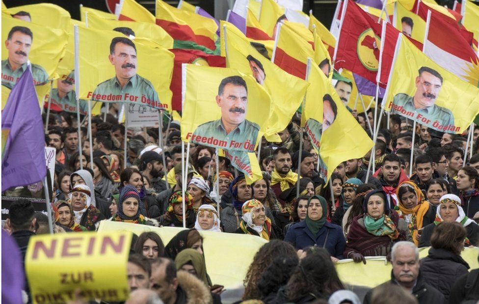 Kurds living in Germany wave flags with portraits of detained Kurdish PKK Leader Abdullah Ocalan in Frankfurt on 18 March, 2017.