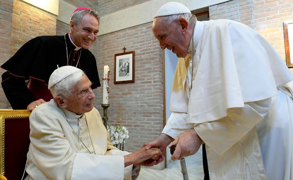 Pope Francis greets Pope Emeritus Benedict XVI during a meeting with newly named Cardinals at the Vatican's Mater Ecclesiae Monastery on August 27, 2022