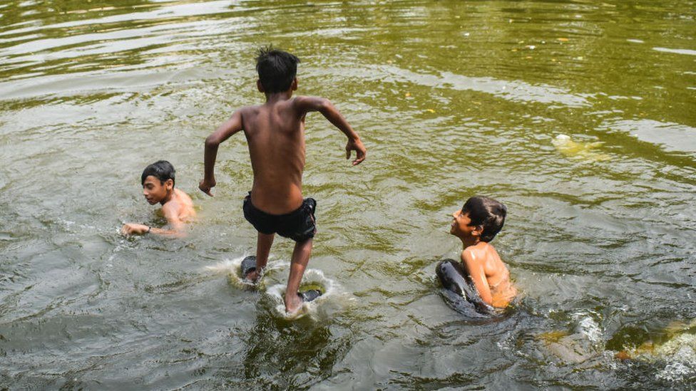 Boys are jumping into a pond to cool off on a hot summer day on the outskirts of Kolkata, India, on March 31, 2024. According to the India Meteorological Department (IMD) report, India is likely to experience a warmer summer with more heatwave days this year, at least until May.