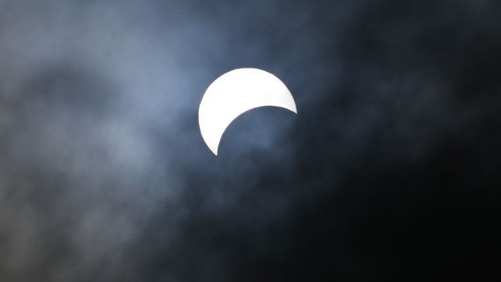 The moon begins to eclipse the sun during a total solar eclipse across North America, at Niagara Falls State Park in Niagara Falls, New York, on April 8, 2024.