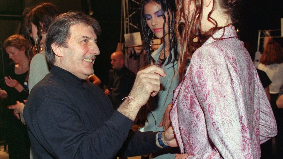 In this file photo taken on January 18, 1999 French designer Emanuel Ungaro checks a dress on a model before his 1999 Spring/Summer Haute Couture collection in Paris