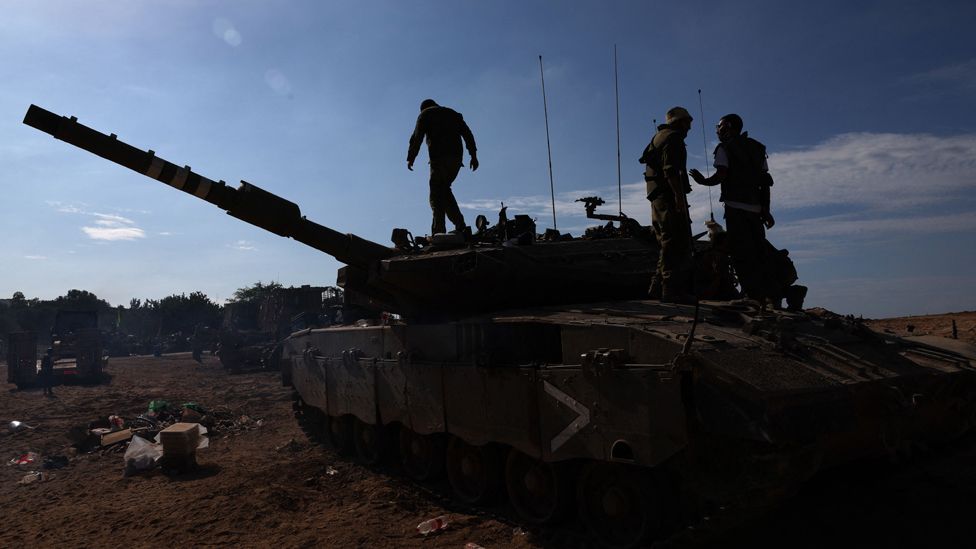 Israeli soldiers are positioned outside kibbutz Beeri near the border with the Gaza Strip on October 17, 2023, in the aftermath of an October 7 attack by Palestinian militants.