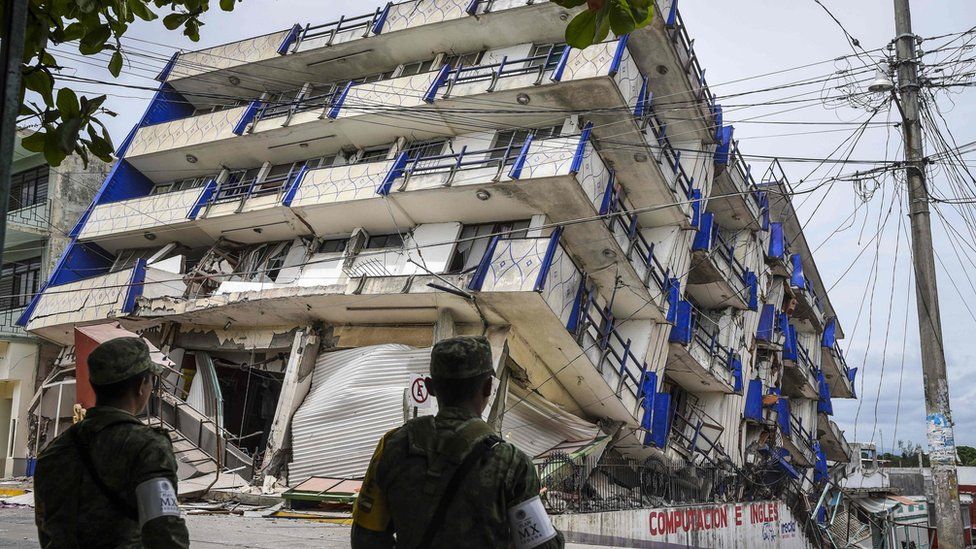 Soldiers stand guard by a hotel which collapsed in the earthquake in Matias Romero, Oaxaca State, on September 8, 2017