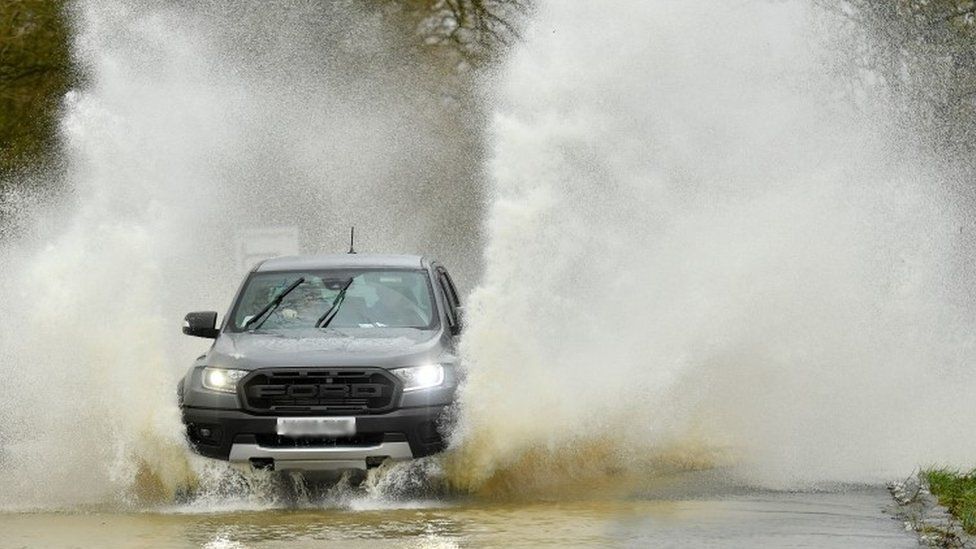 Vehicle navigates flooded road in Leicestershire