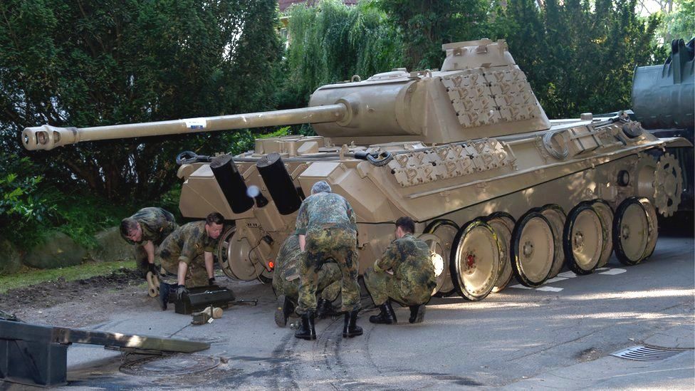 A World War Two Panther battle tank is made ready for transportation from a residential property in Heikendorf, Germany, 2 July 2015